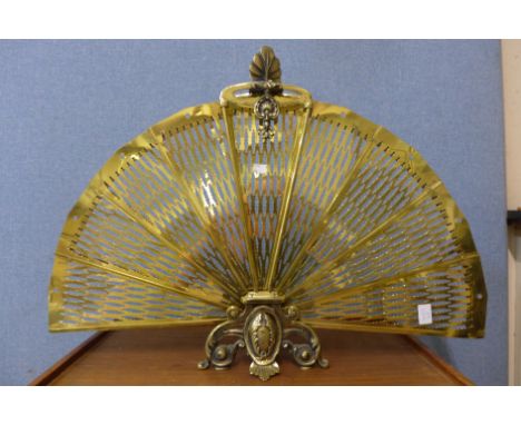 A brass peacock fire screen 