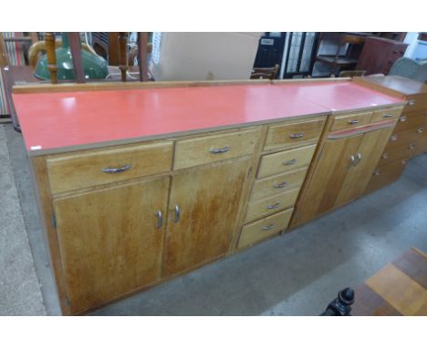 A pair of mid 20th Century light oak and laminated top kitchen cabinets 