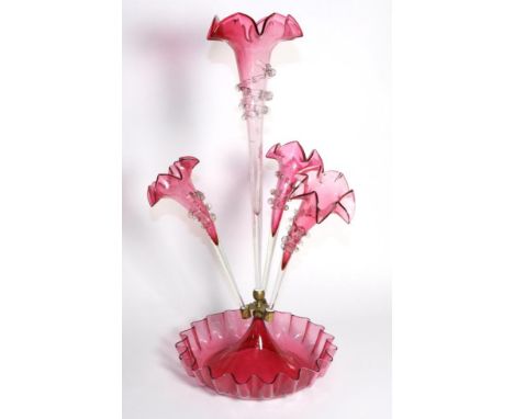 A Cranberry Glass Epergne, with frilled rims, the central trumpet vase flanked by three further vases, on a circular base, 57