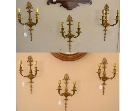 A Set of Six Gilt Metal Twin-Light Wall Sconces, in George III style, cast with anthemion, urns and leaves, 42.5cm high