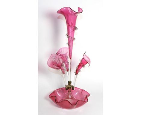 A Cranberry Glass Epergne, the central trumpet vase flanked by three further vases, on a fluted circular base, 54cm high