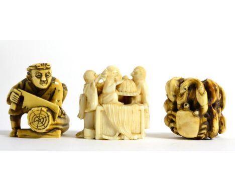 A Japanese Ivory Netsuke, Meiji period, as a wood cutter, 4.2cm; A Similar Netsuke, as figures about a table, 4.5cm; and A Ho