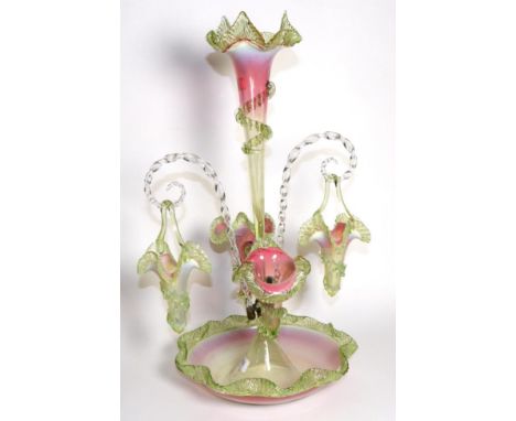 A Pink and Green Vaseline Glass Epergne, with fluted frilled rims, the central trumpet vase flanked by two further vases and 