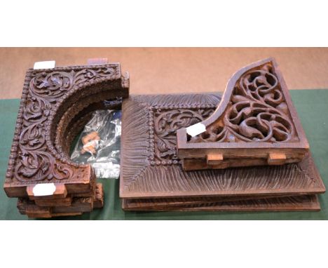 A Set of Three Indian Carved Hardwood Panels, depicting figures amongst scrolling foliage within broad gadrooned borders, 35c