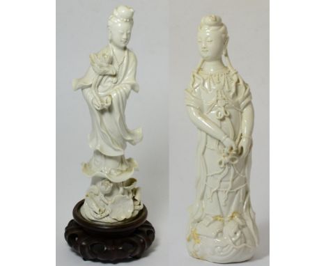 A Chinese Blanc de Chine Figure of Guanyin, Qing Dynasty, standing wearing flowing robes on a scroll base, 26cm high; and A S