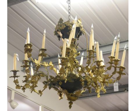 A Gilt and Patinated Metal Twenty-Four Light Chandelier, cast and applied with Bacchic figures and fruiting vine, approx 90cm