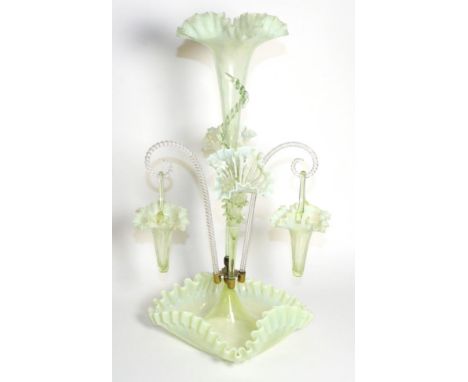 A Vaseline Glass Epergne, with frilled rims, the central trumpet vase flanked by two further vases and two baskets, on a shap