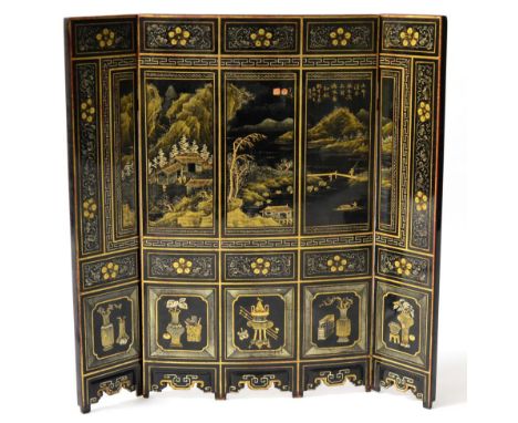 A Chinese Lacquer Three-Section Table Screen, 19th century, decorated in silver and gilt with landscape panels within foliate