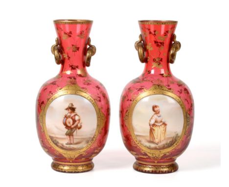 A Pair of Bohemian Ruby Glass Vases, circa 1860, of ovoid form, the flared necks with loop handles, painted with children in 