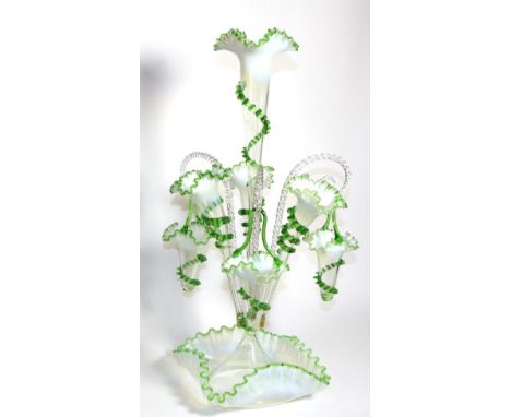 A Green Vaseline Glass Epergne, with frilled rims, the central trumpet vase flanked by three smaller vases and three baskets,