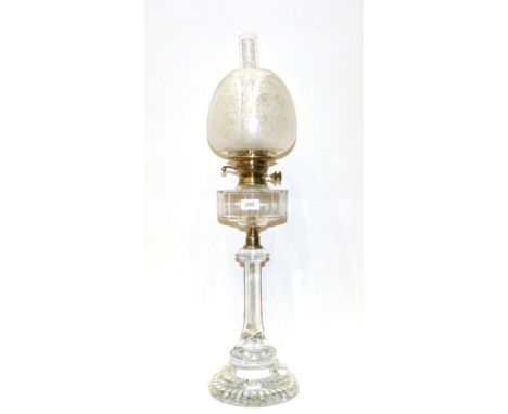 A Glass Oil Lamp, late 19th century, with etched shade, panelled reservoir, stem and stepped foot, 71cm high