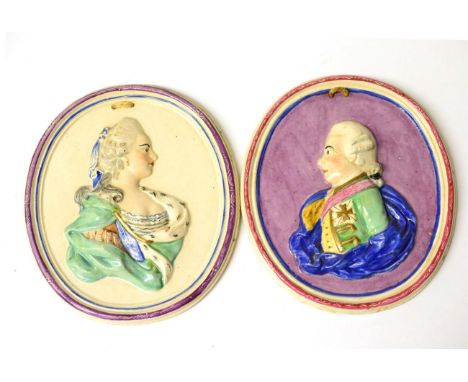 A Pair of Staffordshire Portrait Medallions, early 19th century, moulded and painted with bust portraits possibly of Empress 