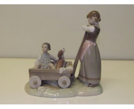 Lladro figure group of girl with a cart containing boy and hound, 21.5cm in height