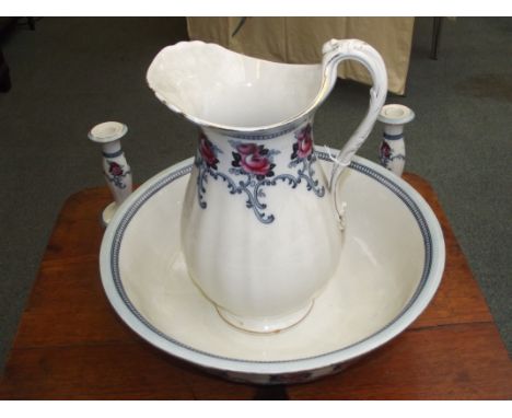 Losol ware wash basin and jug with two candlesticks and a vase.