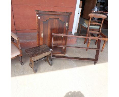 A George III oak wall hanging corner cupboard, a wall hanging shelf and an oak stool 