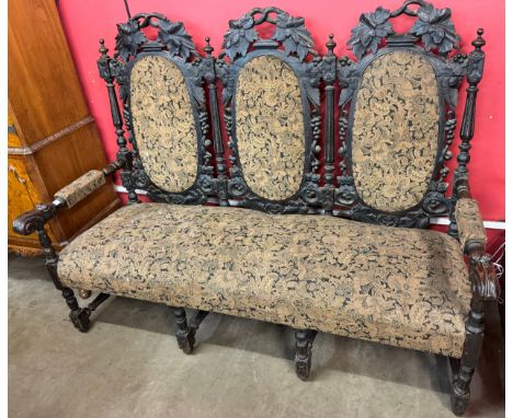 A Victorian Jacobean Revival carved oak settee/sofa 