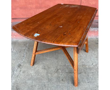 An Ercol elm Windsor drop leaf table 