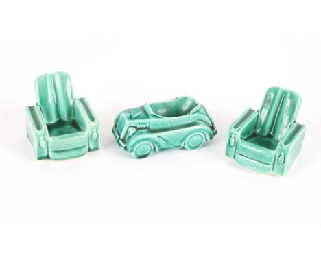 A green pottery pipe rest, in the form of a Vintage car; and a pair of similar in the form of deep seated armchairs