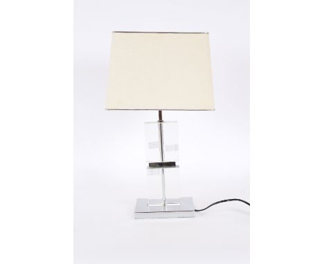 A modern glass and chrome oblong section table lamp, complete with shade