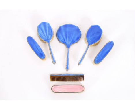 A silver and blue enamel Art Deco style five piece dressing table set; and a silver and pink enamel brush similar (7)