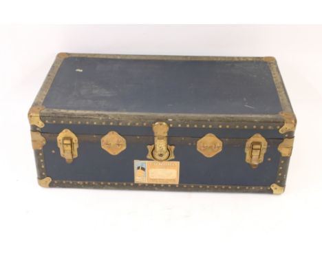 A 1930's metal bound trunk, the interior fitted with removable tray, and bearing luggage label for Queen Mary, Cunard line, a
