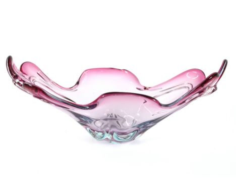 A heavy ruby glass baluster flower vase, 21cm high; and a ruby and mauve tinted boat shaped fruit bowl, 44cm long