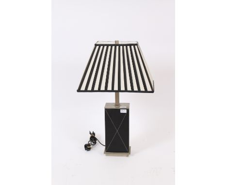 An Art Deco design chrome and leather mounted table lamp, complete with black and white stripe shade