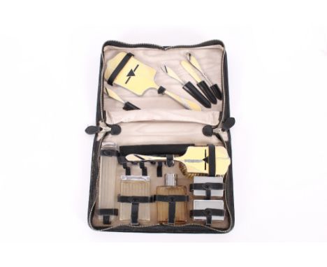 An Art Deco design enamel decorated cased travelling toilet set