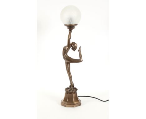 An Art Deco style figural table lamp, in the form of a dancing girl holding a ball aloft on a cobra entwined plinth, 62cm hig