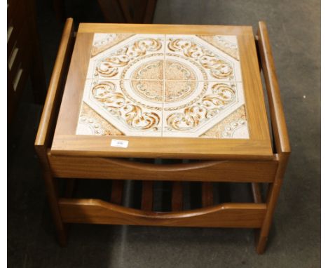 A 1970's G-plan style teak and tile top coffee table, with magazine rack under-tier, 58cm wide