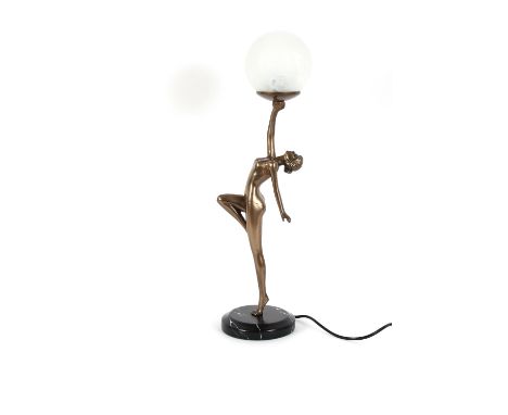 An Art Deco style lamp, in the form of a dancing girl holding a ball aloft, 58cm high
