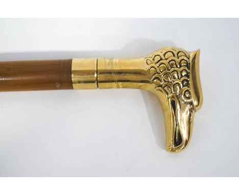 A walking stick with polished brass Griffin's head handle.