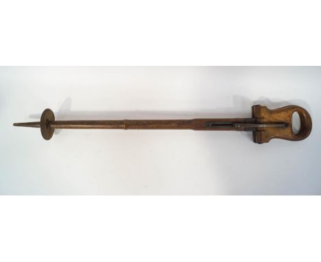 A 19th century shooting stick, the pierced walnut handle opening to for the seat, with sliding steel supports, overall 93cm h