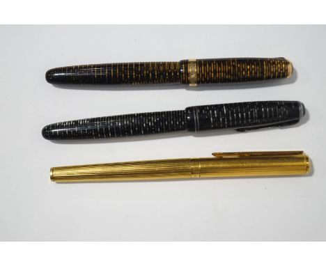 A vintage Parker Vacumatic fountain pen, with 14K nib, made in Canada, brown and gold striated body, a further Parker Vacumat