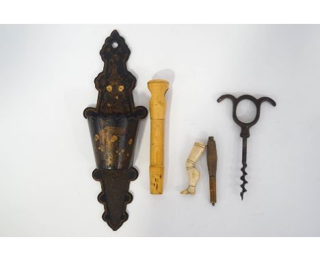 An 18th century bone pipe tamper, carved as a ladies' leg, a Regency lacquered wall pocket with Chinoiserie decoration, a pai