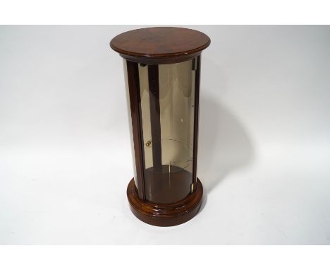 A mahogany framed cylindrical display cabinet with adjustable shelf on plinth base, 88cm high x 41cm diameter