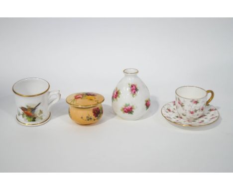 Four miniature porcelain ornaments, comprising a Royal Worcester box and cover, Royal Worcester mug, a Doulton vase and a Coa