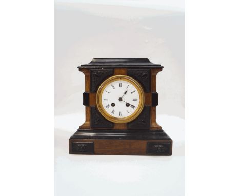 A late 19th century walnut and ebonised mantel clock, with two train movement striking on a bell, 25cm high