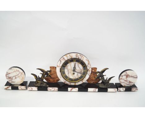 An Art deco style clock garniture with pink marble and slate case with patinated spelter birds flanking the round dial, 54cm 