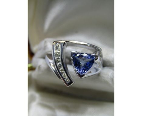18CT WHITE GOLD &amp; TANZANITE DIAMOND RING; Trillion cut Tanzanite of approx 1.5ct set with 7 well matched channel set bril