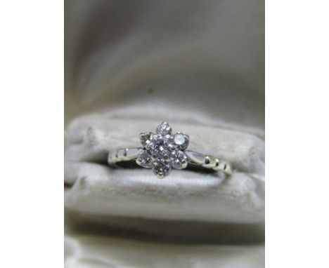 9ct WHITE GOLD DIAMOND DAISY CLUSTER RING, 7 bright well matched diamonds set to form a daisy, size O/P 