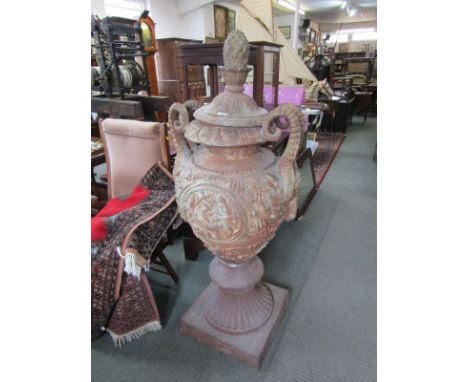 ANTIQUE CAST IRON URN, an impressive garden cast iron urn, the foliate decorated body with rams head handles the lid with pin