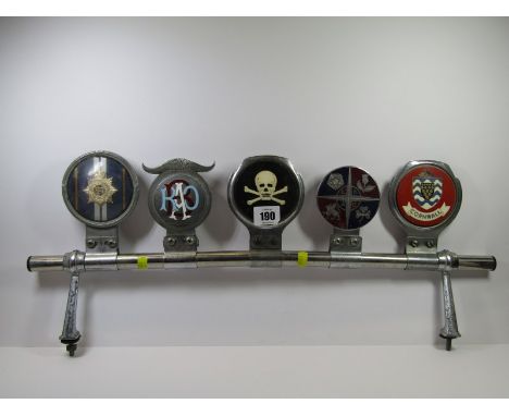 MOTORING, 5 assorted vintage car badges on chrome bar 