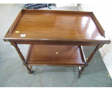 OAK CARD TABLE/TEA TROLLEY, 20th Century swivel top card table, fitted lower shelf on turned supports and castor feet, 30" 