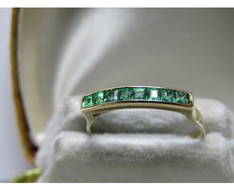 14ct YELLOW GOLD EMERALD HALF ETERNITY STYLE RING; Set with 8 channel set Princess cut emeralds, size 'M/N' 