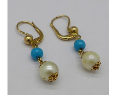 A pair of yellow metal pearl set drop earrings