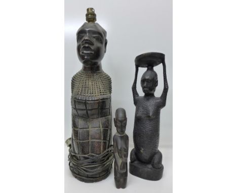 A carved African table lamp base and two other African carvings, height of lamp base 44cm