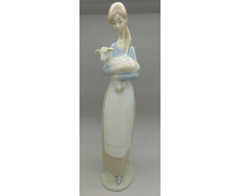 A Lladro figure of a woman with lamb, height 26.5cm