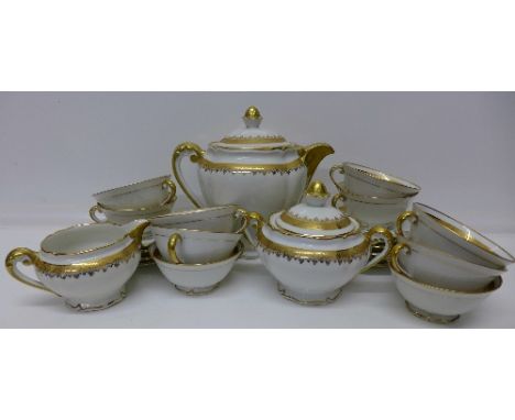A Limoges French porcelain ten setting tea service with teapot, cream and sugar