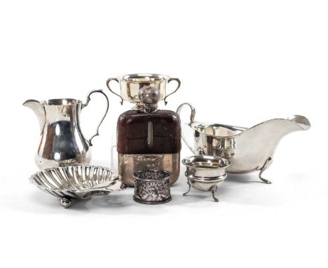 GROUP OF SILVER comprising small silver trophy cup on stand, silver pot bellied jug, silver and leather hip falsk, silver she